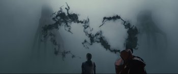 Movie still from “Arrival” (2016), directed by Denis Villeneuve – Two people standing in front of a cloud filled sky; Wide shot, Overhead angle