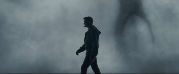 Movie still from “Arrival” (2016), directed by Denis Villeneuve – A man walking in the middle of a foggy area; Wide shot, Low angle