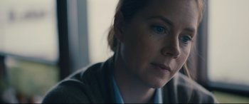 Movie still from “Arrival” (2016), directed by Denis Villeneuve – A woman's face in a room; Close Up shot, Over the shoulder angle