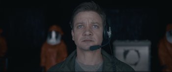 Movie still from “Arrival” (2016), directed by Denis Villeneuve – A man wearing a headset looking at the camera; Close Up shot, Low angle