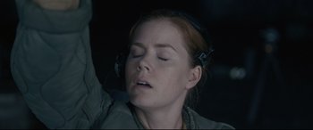 Movie still from “Arrival” (2016), directed by Denis Villeneuve – A person wearing headphones; Close Up shot, Low angle