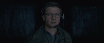 Movie still from “Arrival” (2016), directed by Denis Villeneuve – A man wearing a headset and looking at the camera; Close Up shot, Low angle