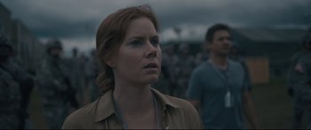 Movie still from “Arrival” (2016), directed by Denis Villeneuve – A person wearing a brown shirt; Close Up shot, Over the shoulder angle