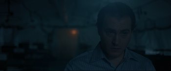 Movie still from “Arrival” (2016), directed by Denis Villeneuve – A man in a striped shirt is looking at the camera; Close Up shot, Low angle