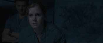 Movie still from “Arrival” (2016), directed by Denis Villeneuve – A woman in a jacket is looking at the camera; Close Up shot, High angle