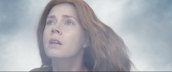 Movie still from “Arrival” (2016), directed by Denis Villeneuve – A person with long red hair; Close Up shot, Low angle