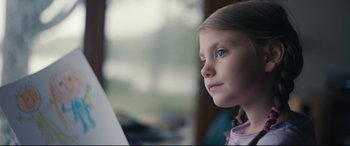 Movie still from “Arrival” (2016), directed by Denis Villeneuve – A little girl with blue eyes looking at something on the wall; Close Up shot, Low angle