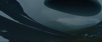 Movie still from “Arrival” (2016), directed by Denis Villeneuve – A plane is flying in the sky on a cloudy day; Extreme Wide shot, Low angle