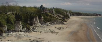Movie still from “Artemis Fowl” (2020), directed by Kenneth Branagh – A painting of a lighthouse on the side of a cliff; Extreme Wide shot, High angle
