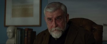Movie still from “Artemis Fowl” (2020), directed by Kenneth Branagh – An older man with a beard and a white mustache; Close Up shot, Over the shoulder angle