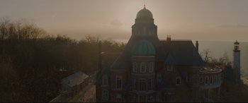 Movie still from “Artemis Fowl” (2020), directed by Kenneth Branagh – An aerial view of a large building with a dome; Extreme Wide shot, Low angle