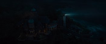 Movie still from “Artemis Fowl” (2020), directed by Kenneth Branagh – An aerial view of a light house at night time; Extreme Wide shot, High angle