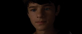 Movie still from “Artemis Fowl” (2020), directed by Kenneth Branagh – A young boy's face in the dark; Close Up shot, High angle