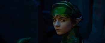 Movie still from “Artemis Fowl” (2020), directed by Kenneth Branagh – A young boy wearing a green outfit and a hat; Close Up shot, High angle
