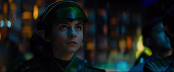 Movie still from “Artemis Fowl” (2020), directed by Kenneth Branagh – A woman wearing a green uniform looking up; Close Up shot, Low angle