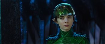 Movie still from “Artemis Fowl” (2020), directed by Kenneth Branagh – A young boy dressed in a green outfit and wearing a helmet; Close Up shot, Over the shoulder angle