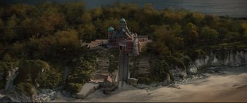 Movie still from “Artemis Fowl” (2020), directed by Kenneth Branagh – An aerial view of a castle with a sky background; Extreme Wide shot, High angle