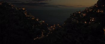 Movie still from “Artemis Fowl” (2020), directed by Kenneth Branagh – A view of the ocean at night from a hill; Extreme Wide shot, High angle