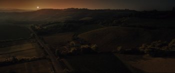 Movie still from “Artemis Fowl” (2020), directed by Kenneth Branagh – An aerial view of a field at sunset; Extreme Wide shot, High angle