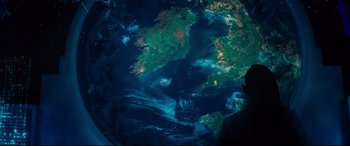 Movie still from “Artemis Fowl” (2020), directed by Kenneth Branagh – A satellite image of the earth at night time; Medium shot, Overhead angle