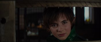 Movie still from “Artemis Fowl” (2020), directed by Kenneth Branagh – A young woman with short brown hair is looking at the camera; Close Up shot, Over the shoulder angle
