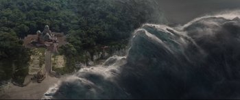 Movie still from “Artemis Fowl” (2020), directed by Kenneth Branagh – A man flying through the air over a body of water; Extreme Wide shot, Overhead angle