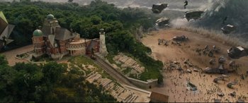 Movie still from “Artemis Fowl” (2020), directed by Kenneth Branagh – An aerial view of a train station and a lighthouse; Extreme Wide shot, High angle