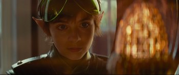 Movie still from “Artemis Fowl” (2020), directed by Kenneth Branagh – A young boy wearing a green hat looking at the camera; Close Up shot, Over the shoulder angle