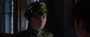 Movie still from “Artemis Fowl” (2020), directed by Kenneth Branagh – A young boy wearing a green costume and a helmet; Close Up shot, Over the shoulder angle