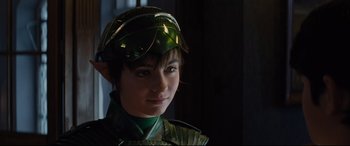 Movie still from “Artemis Fowl” (2020), directed by Kenneth Branagh – A young boy dressed in a green costume; Close Up shot, Over the shoulder angle