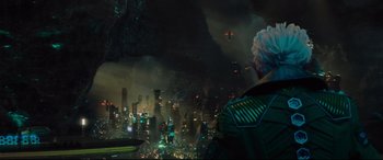 Movie still from “Artemis Fowl” (2020), directed by Kenneth Branagh – An image of a man looking out over a city at night; Wide shot, Over the shoulder angle