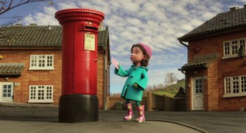Movie still from “Arthur Christmas” (2011), directed by Barry Cook – A girl in a raincoat is standing next to a mailbox; Wide shot, Low angle