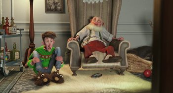 Movie still from “Arthur Christmas” (2011), directed by Barry Cook – Two cartoon characters sitting in a chair with a teddy bear; Wide shot, High angle