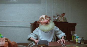 Movie still from “Arthur Christmas” (2011), directed by Barry Cook – An animated character sitting at a table with a knife; Medium shot, Low angle