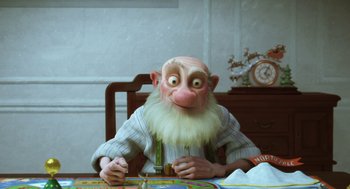 Movie still from “Arthur Christmas” (2011), directed by Barry Cook – An old man sitting at a table in front of an alarm clock; Medium shot, High angle