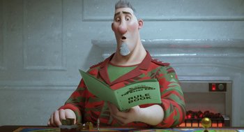 Movie still from “Arthur Christmas” (2011), directed by Barry Cook – A man in a red and green jacket is reading a rulebook; Medium shot, Over the shoulder angle