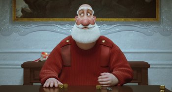 Movie still from “Arthur Christmas” (2011), directed by Barry Cook – An old man with a beard is sitting at a table; Medium shot, Low angle