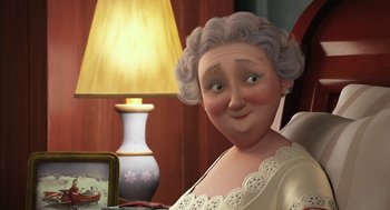 Movie still from “Arthur Christmas” (2011), directed by Barry Cook – An old woman with gray curly hair is smiling; Close Up shot, Over the shoulder angle