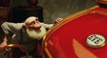 Movie still from “Arthur Christmas” (2011), directed by Barry Cook – A man with a beard and a mustache is leaning on a large object; Medium shot, Low angle