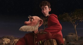 Movie still from “Arthur Christmas” (2011), directed by Barry Cook – A man and a boy are standing next to each other; Medium shot, Low angle
