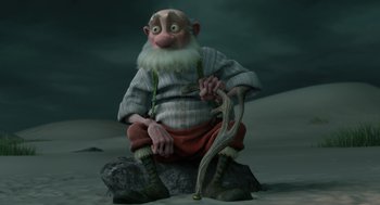 Movie still from “Arthur Christmas” (2011), directed by Barry Cook – An old man sitting on a rock holding a cane; Wide shot, Low angle