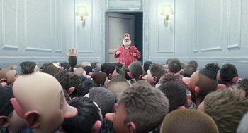 Movie still from “Arthur Christmas” (2011), directed by Barry Cook – A crowd of people in a room with a man standing in front of a door; Wide shot, Over the shoulder angle