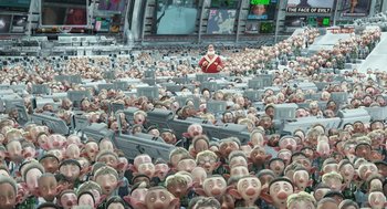 Movie still from “Arthur Christmas” (2011), directed by Barry Cook – A large group of animated characters in a room with a woman in a red dress; Extreme Wide shot, High angle