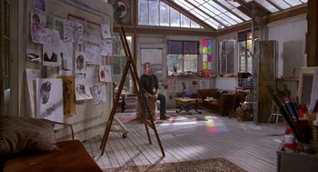 Movie still from “As Good as It Gets” (1997), directed by James L. Brooks – A man sitting in front of an easel in a room; Wide shot, High angle