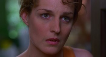 Movie still from “As Good as It Gets” (1997), directed by James L. Brooks – A woman's face with green eyes; Close Up shot, Over the shoulder angle