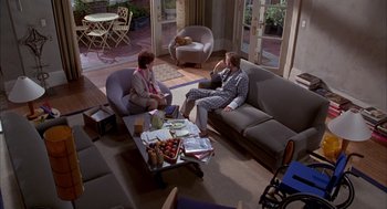 Movie still from “As Good as It Gets” (1997), directed by James L. Brooks – Two people sitting on couches in a living room; Wide shot, High angle