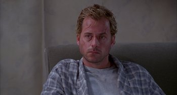 Movie still from “As Good as It Gets” (1997), directed by James L. Brooks – A person sitting in a chair; Close Up shot, Low angle
