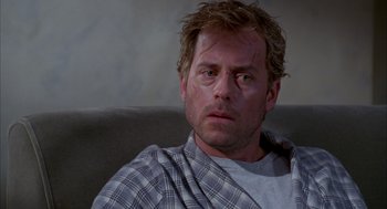 Movie still from “As Good as It Gets” (1997), directed by James L. Brooks – A person sitting on a couch; Close Up shot, Over the shoulder angle