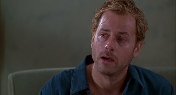 Movie still from “As Good as It Gets” (1997), directed by James L. Brooks – A person sitting on a couch with water on his face; Close Up shot, Low angle