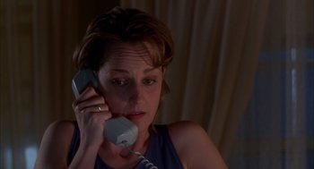 Movie still from “As Good as It Gets” (1997), directed by James L. Brooks – A woman holding a phone up to her ear; Close Up shot, High angle